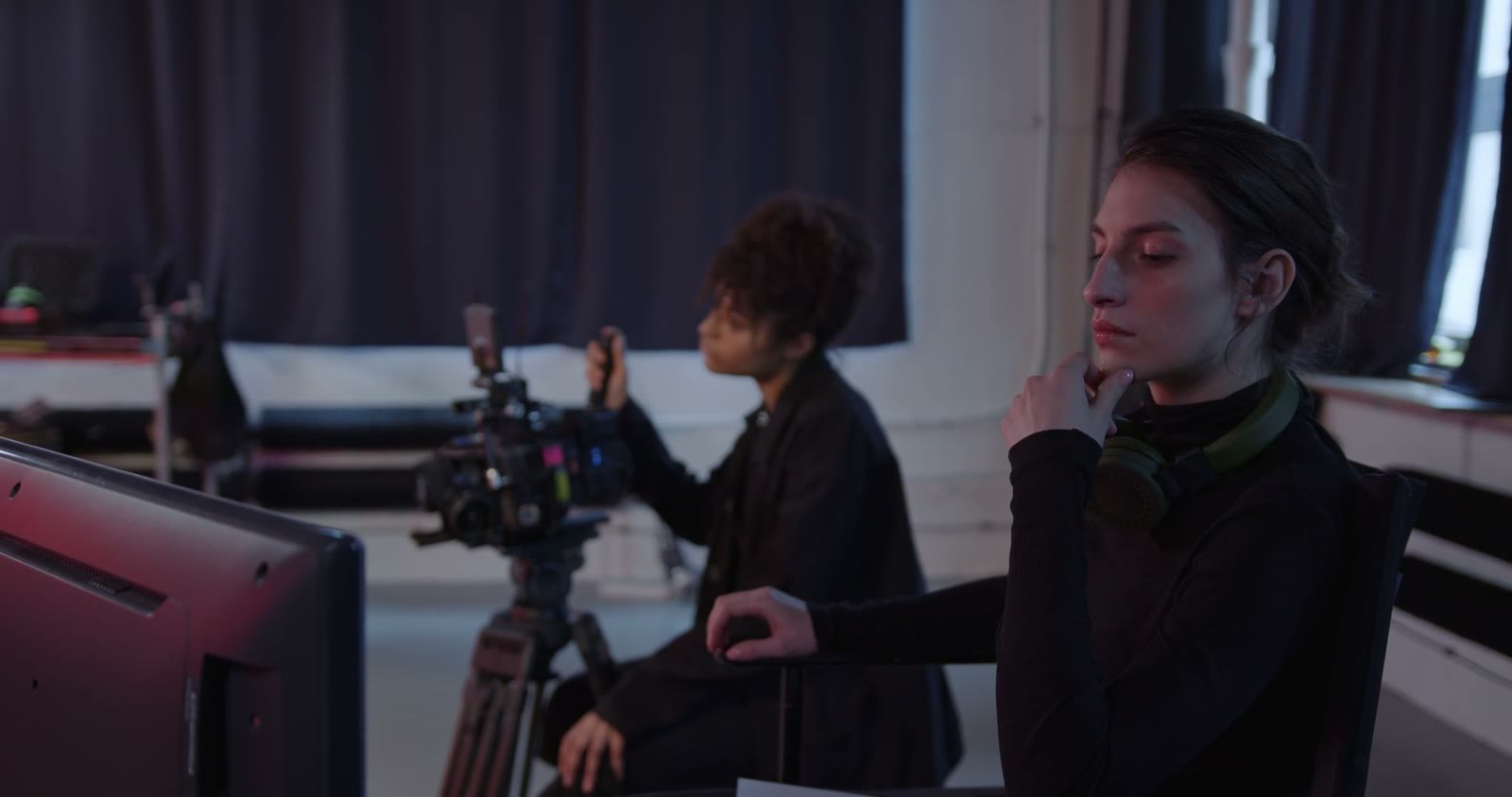 A director and camera operator shooting a scene on location.